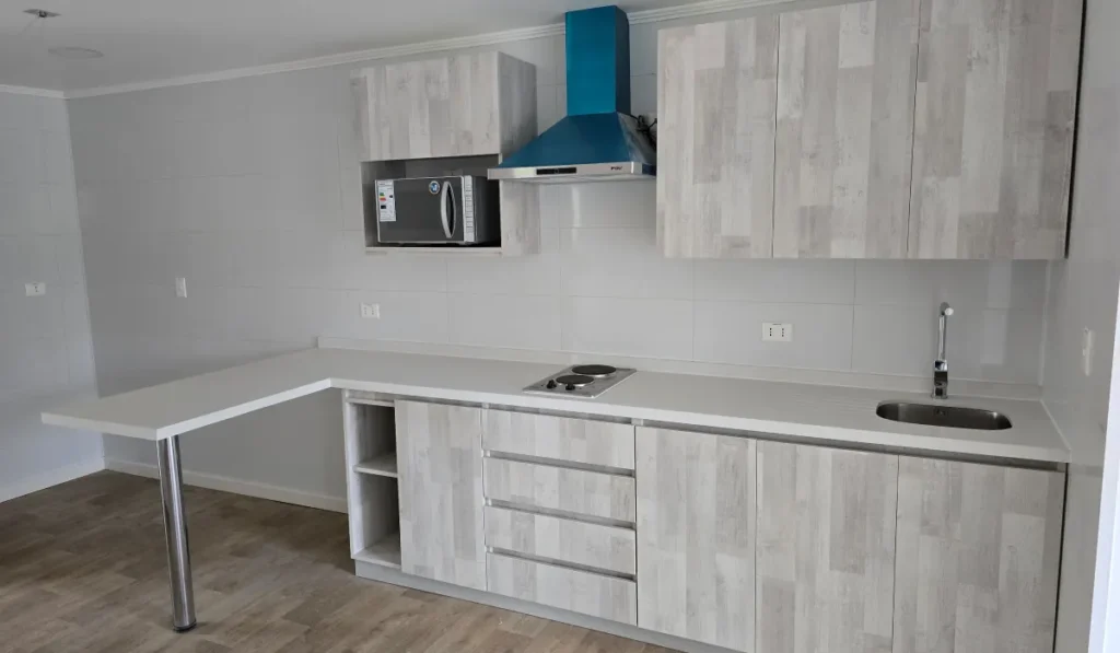 Cocina equipada con encimera, campana y muebles modulares